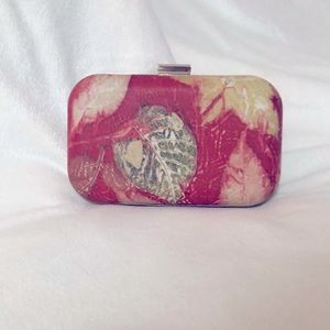 Handcrafted genuine leather clutch with detachable chain.